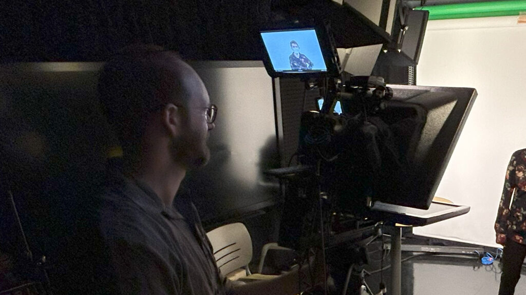 Hugh behind the camera in a production studio